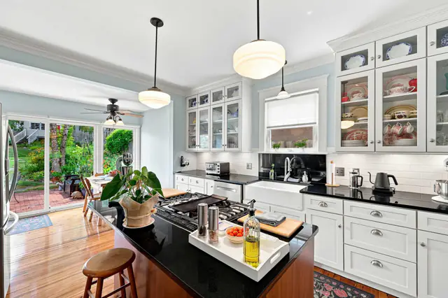 Renovated farmhouse kitchen opening to a garden patio, photographed for a Shenandoah Valley listing