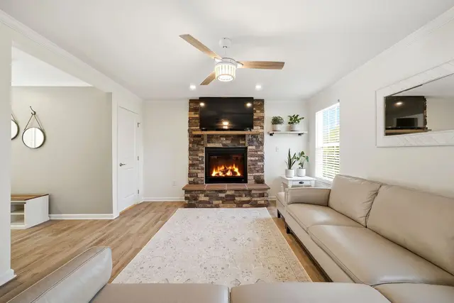 Interior photography  -  living room with lit stone fireplace